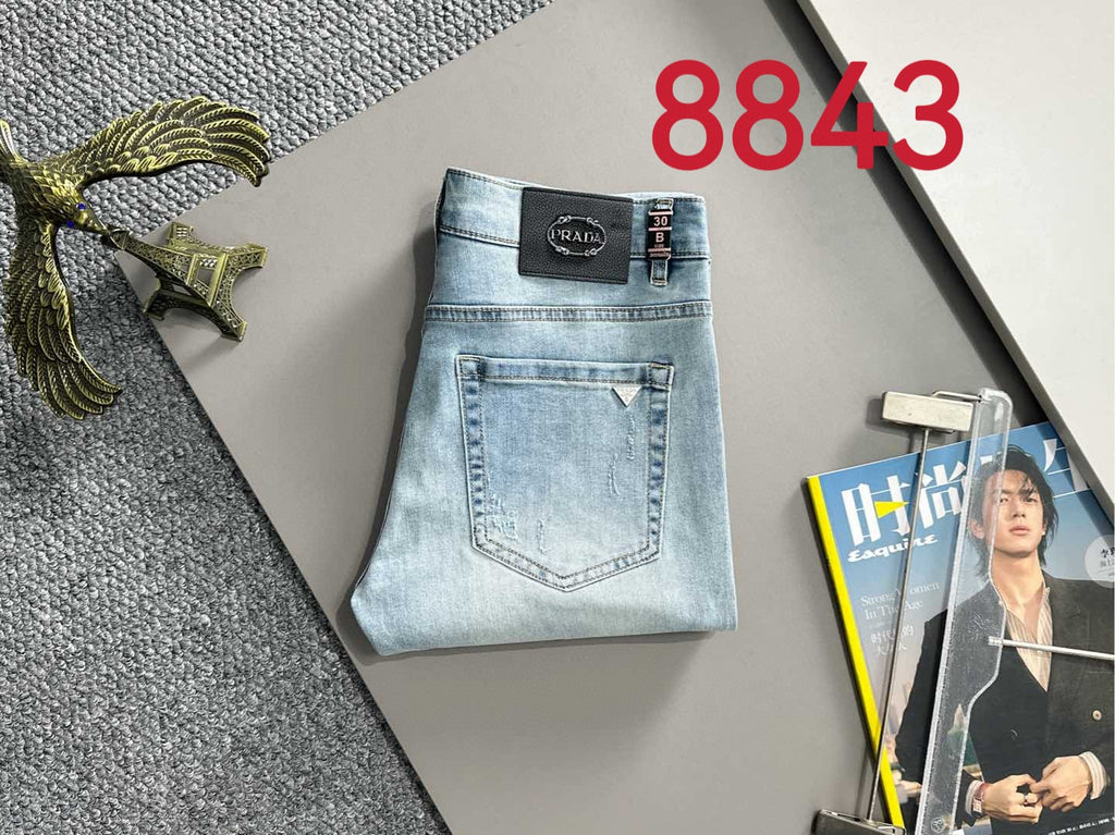 Light blue denim pants with Prada logo label and back pocket stitching.