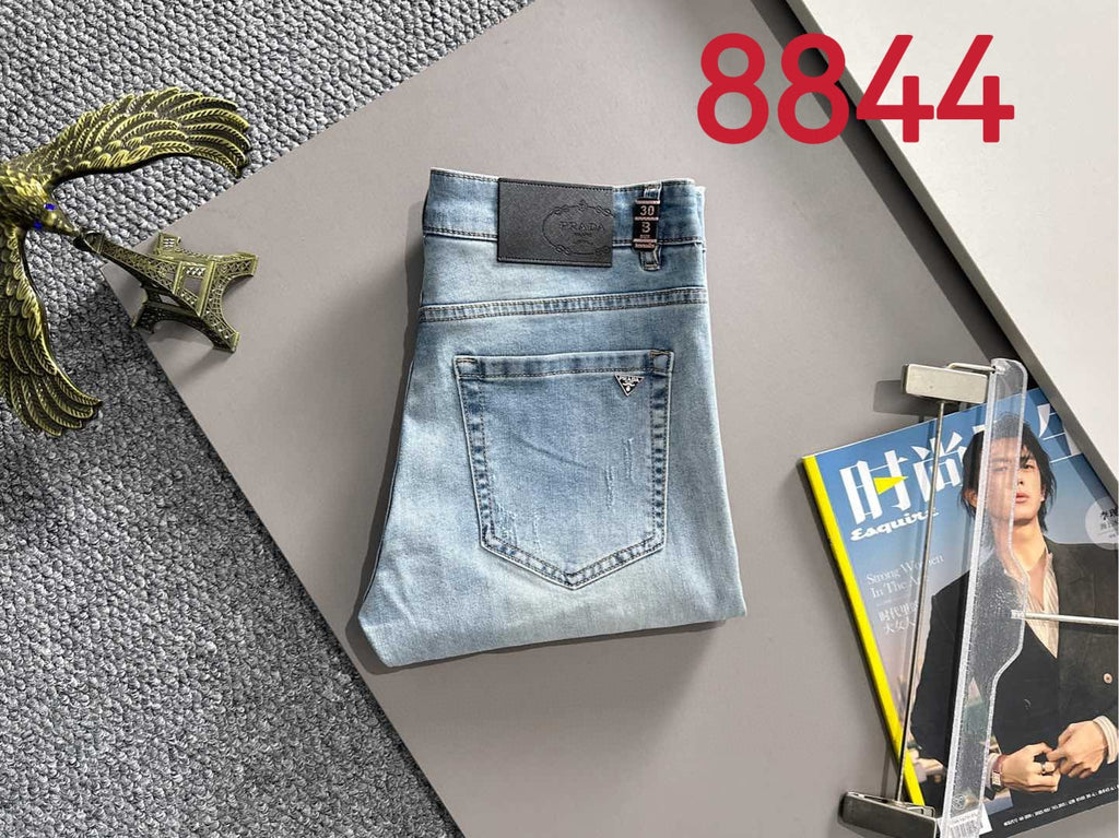 Light blue denim pants with square logo patch on waistband and back pocket