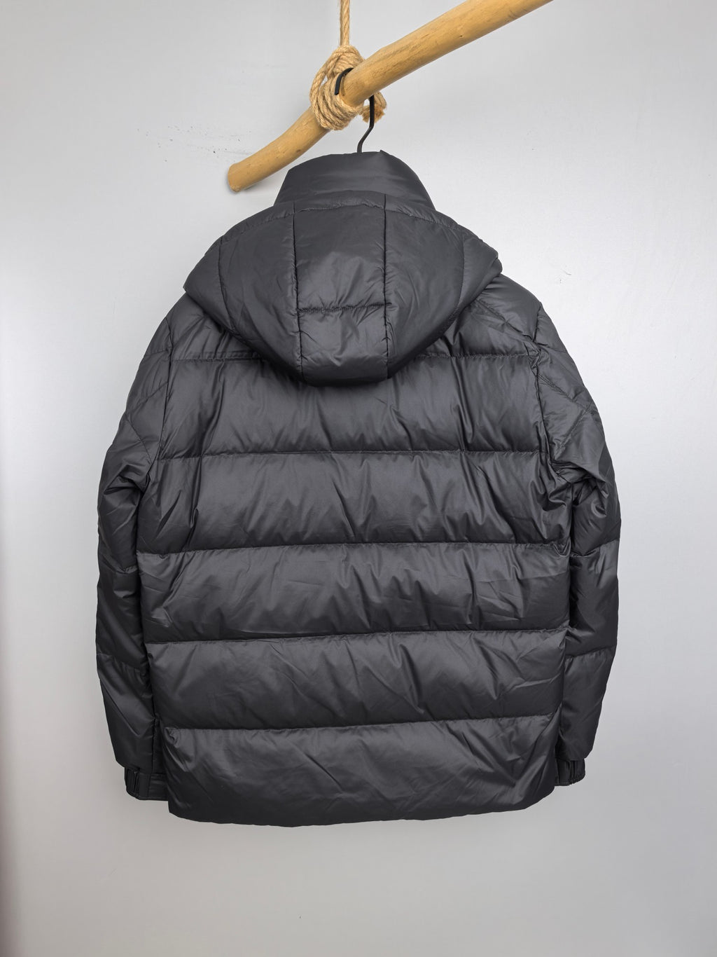 Long Moncler puffer jacket, dark gray, back view with attached hood
