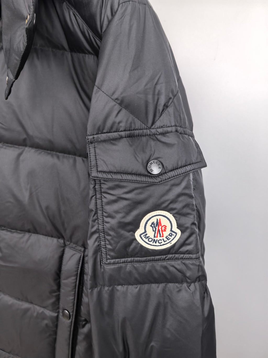 Long Moncler puffer jacket sleeve with Moncler patch and snap cuff