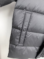Long Moncler puffer jacket side panel with stitched seam and button placket
