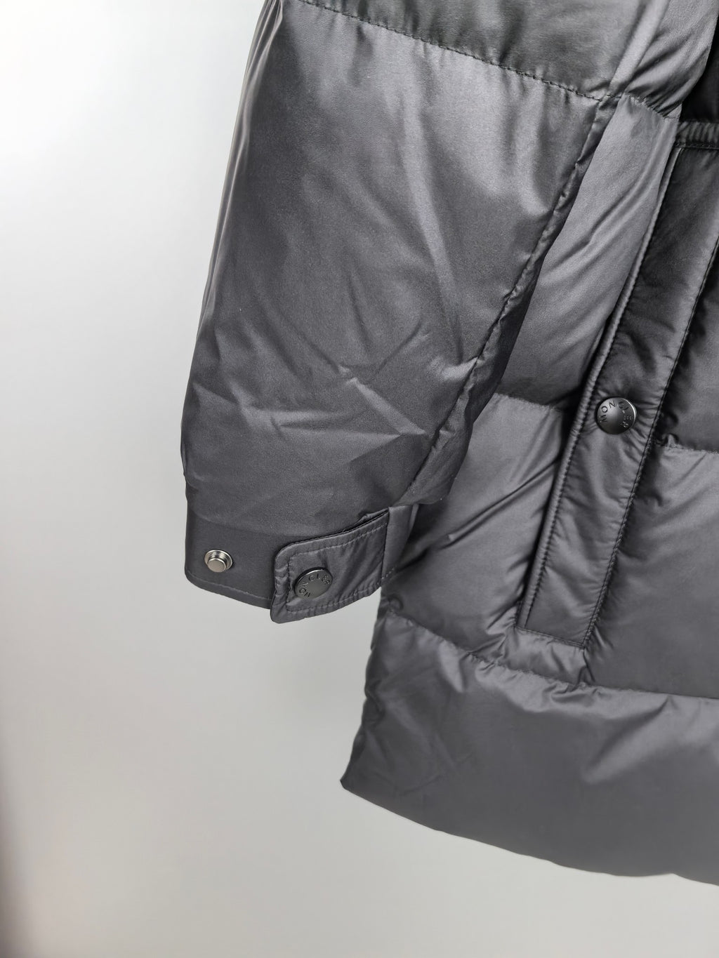 Long Moncler puffer jacket cuff with snap buttons and fabric paneling
