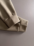 Beige sweatshirt sleeve cuff with white ribbed hem detail