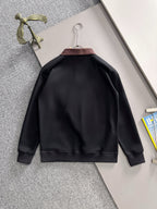 Black long-sleeve sweatshirt back view on hanger