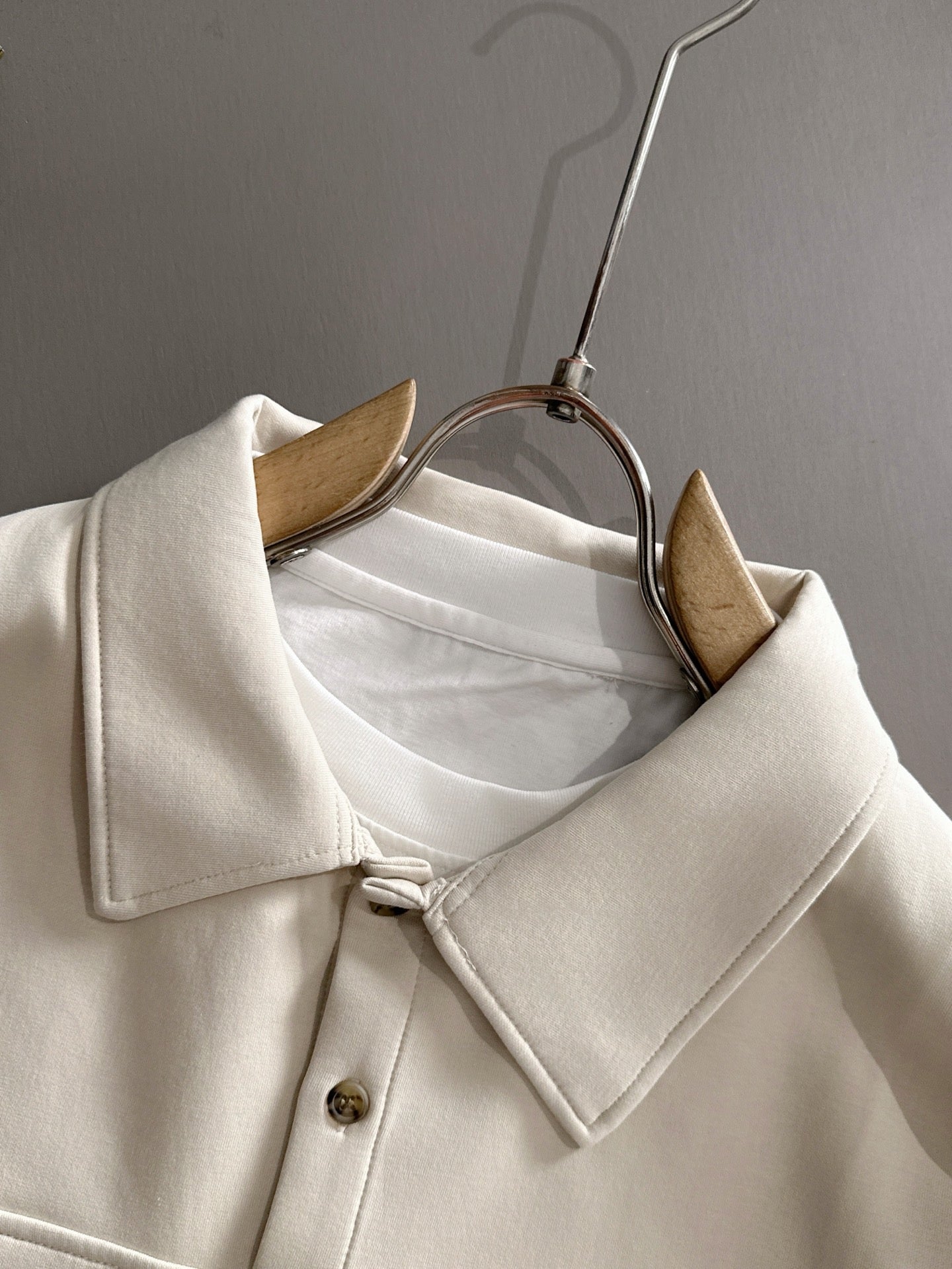 Dior long-sleeve polo shirt on hanger, light cream with button placket and collar