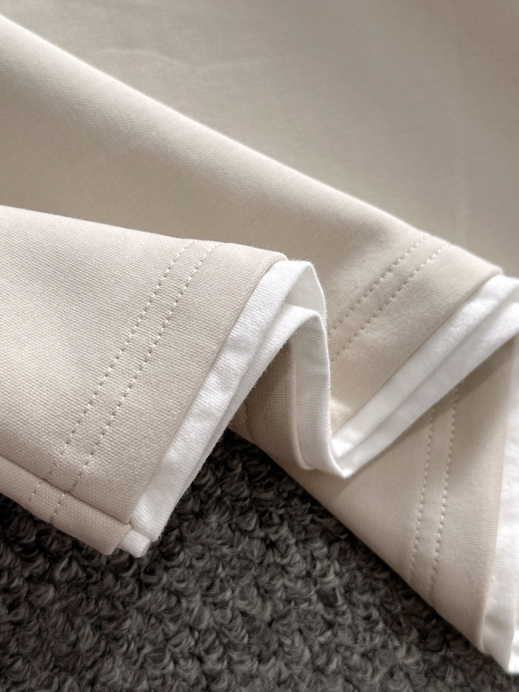 Dior long-sleeve polo shirt sleeve cuff detail in light cream with visible stitching