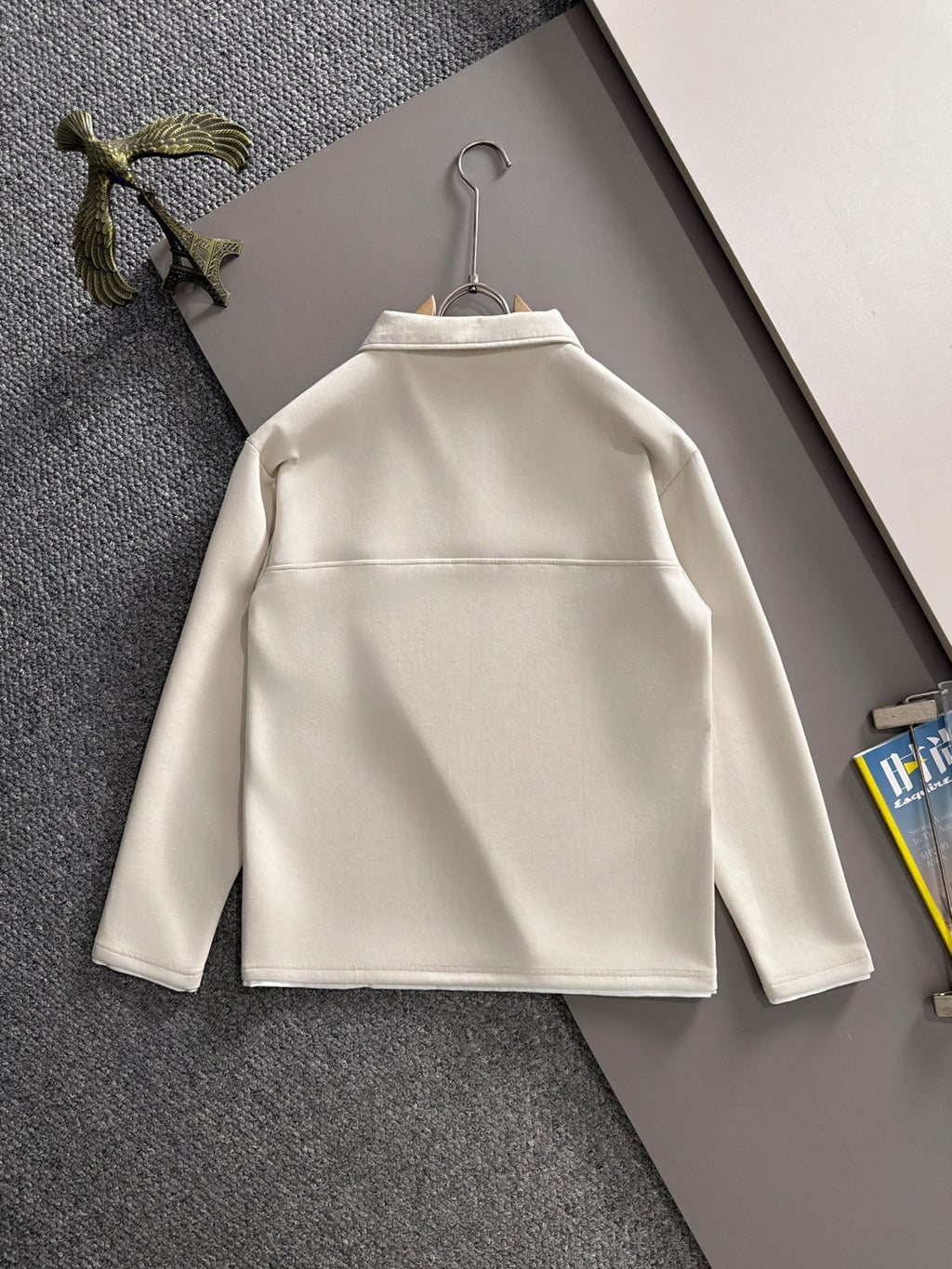 Dior long-sleeve polo shirt back view on hanger, light cream