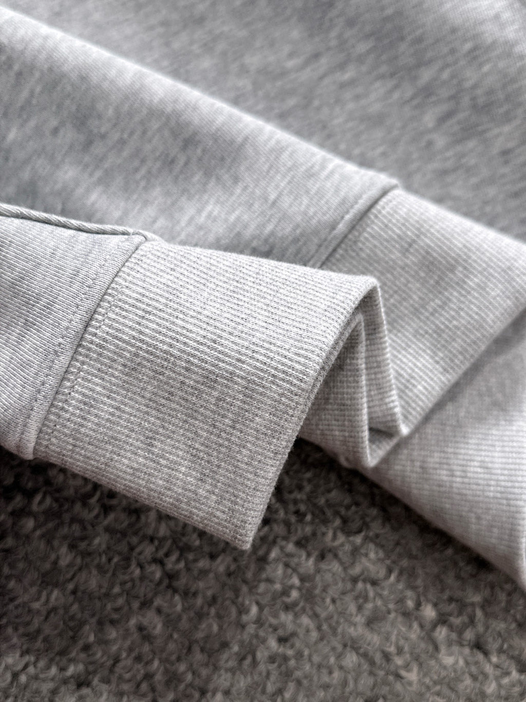 Light gray pullover sleeve cuff with ribbed knit hem