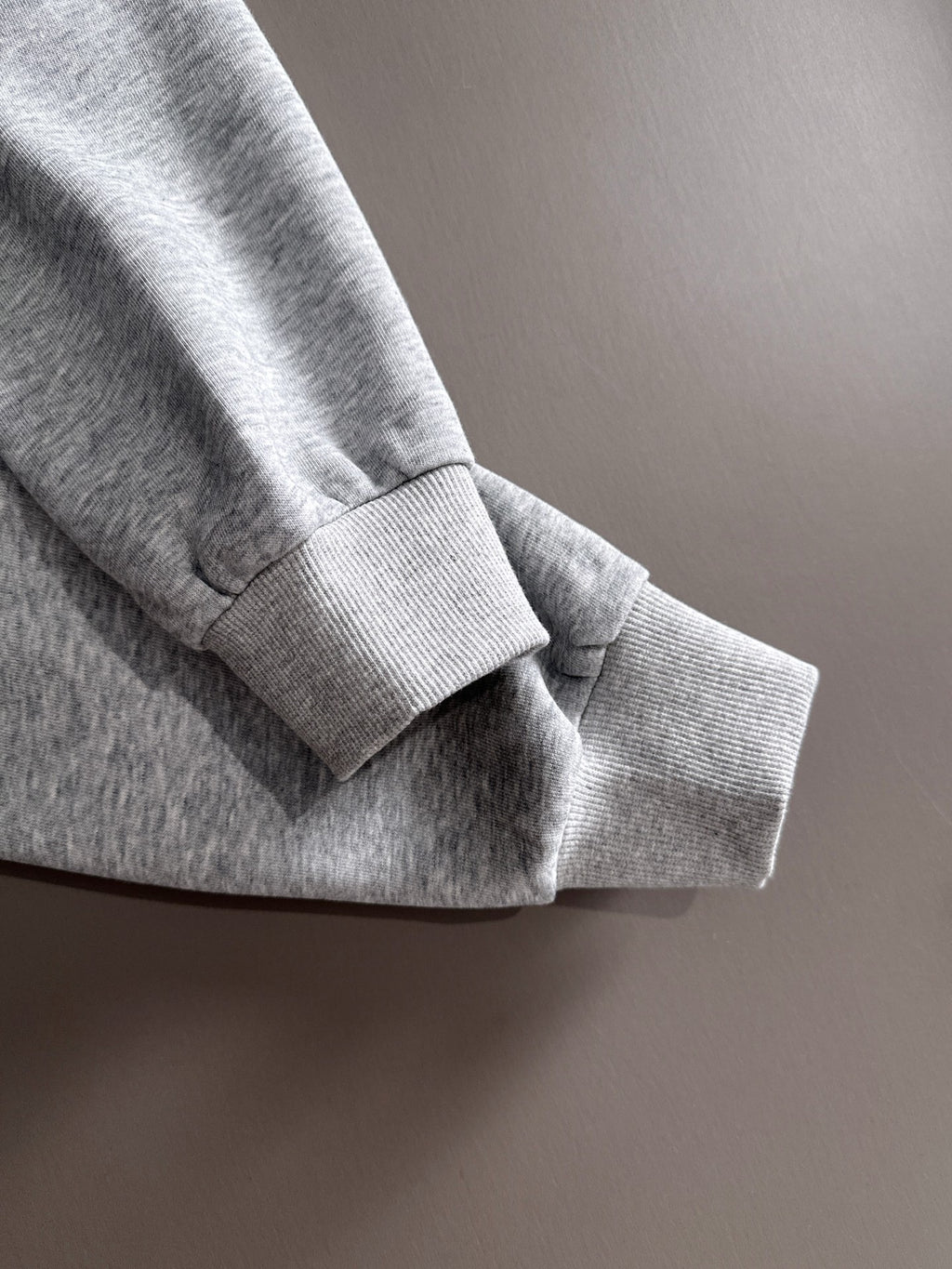 Light gray pullover sleeve cuff and hem detail