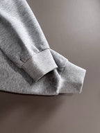 Light gray pullover sleeve cuff and hem detail