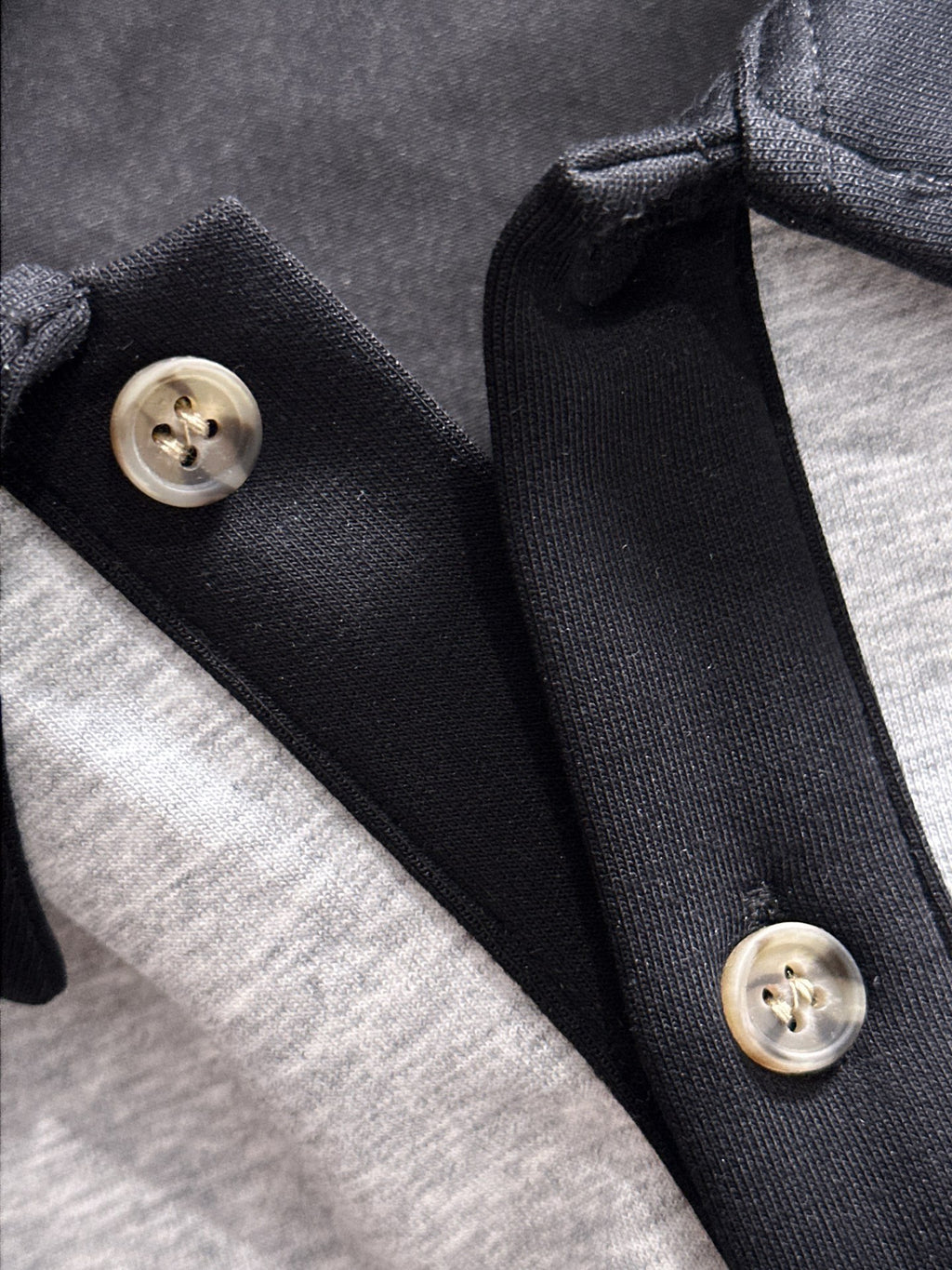 Two-tone long-sleeve shirt collar detail with black buttons and snap placket