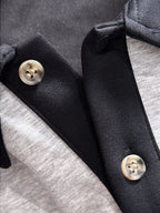Two-tone long-sleeve shirt collar detail with black buttons and snap placket
