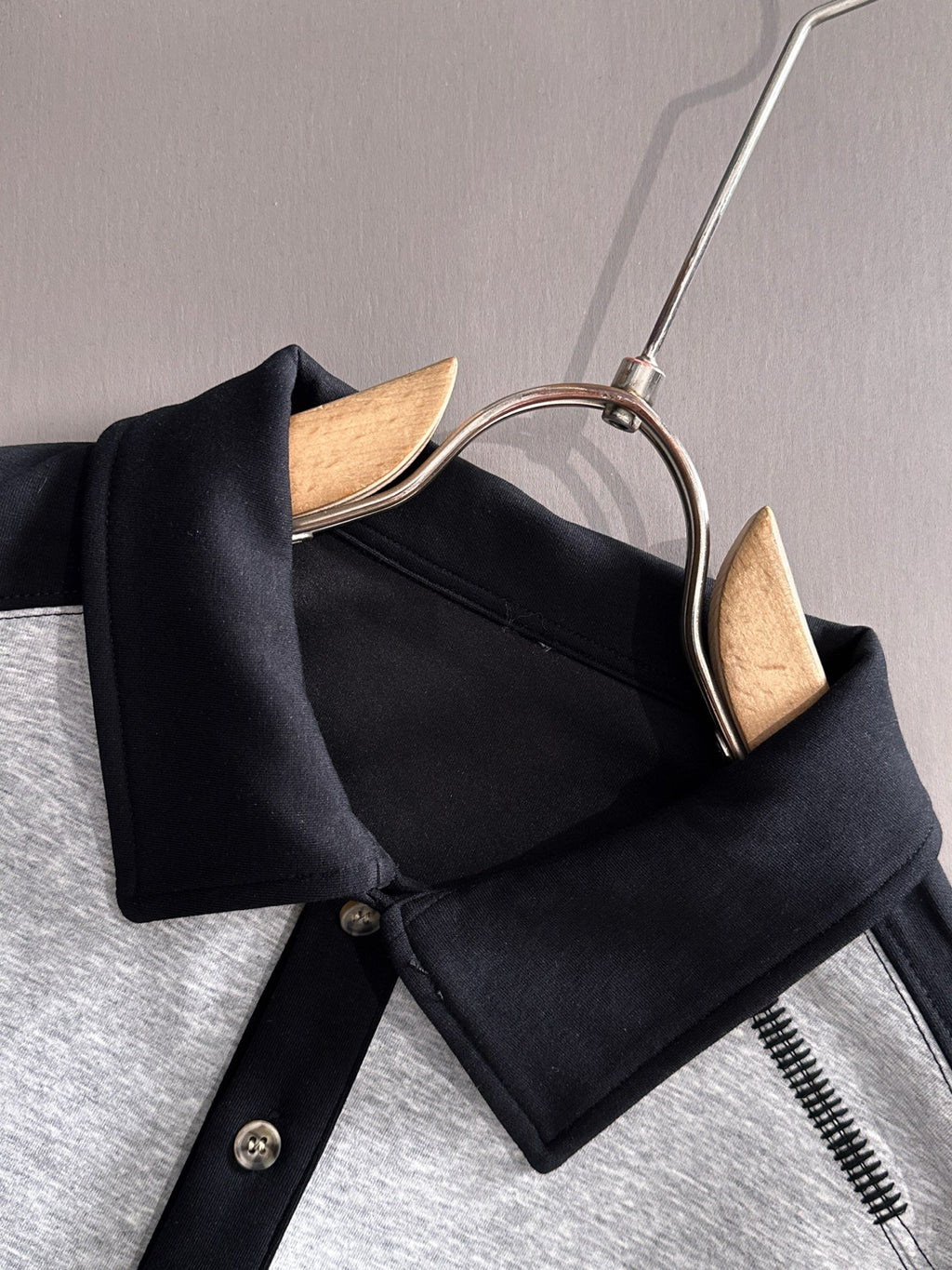 Two-tone long-sleeve shirt neckline detail with black collar and snap buttons