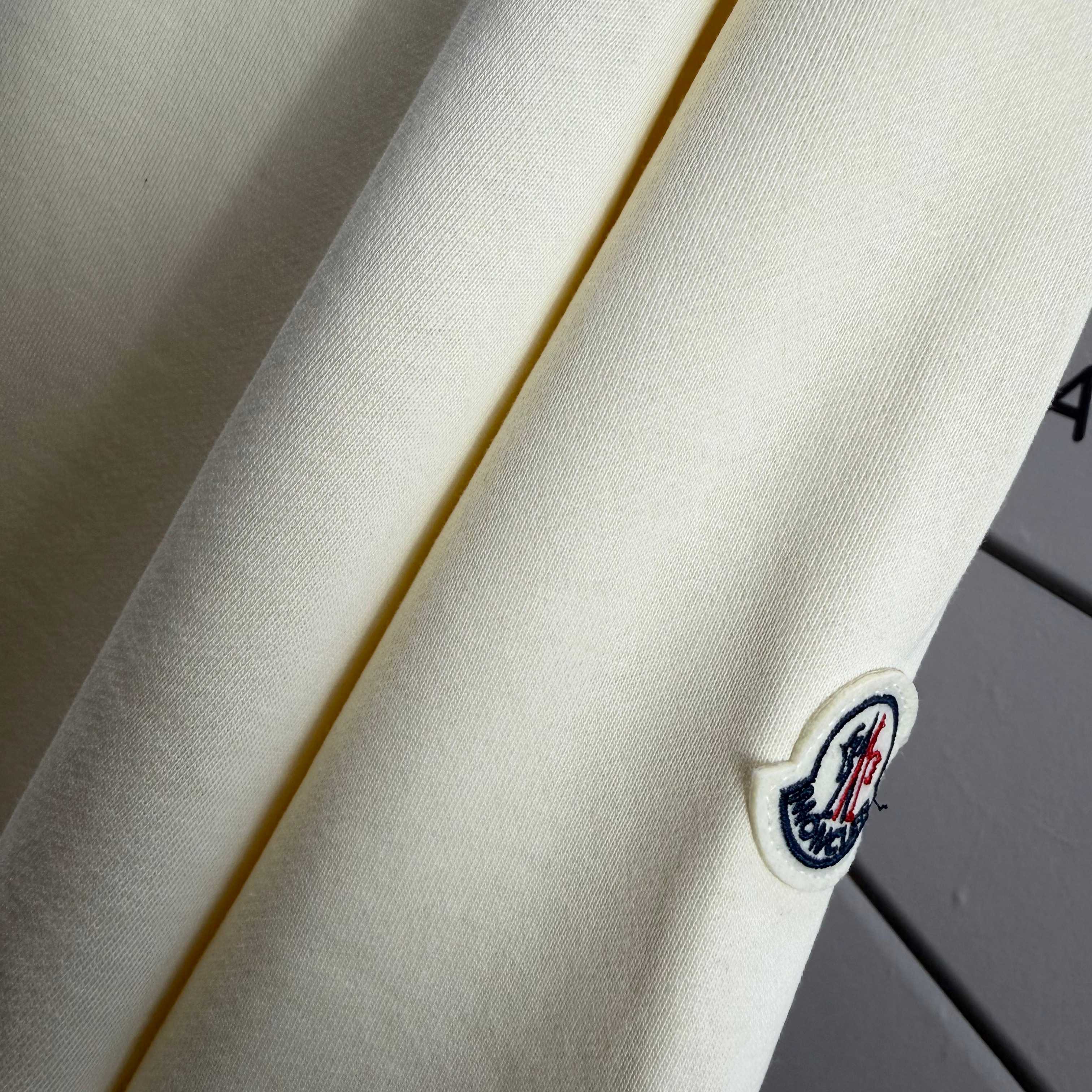Moncler crewneck sweatshirt sleeve with small circular logo patch