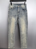 Light wash denim jeans with straight legs, front button and zip closure, belt loops