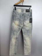 Light wash denim jeans on a hanger, classic five-pocket design and belt loops