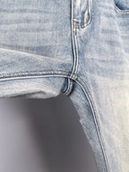 Denim jeans front knee and inner seam with curved stitching and hem edge