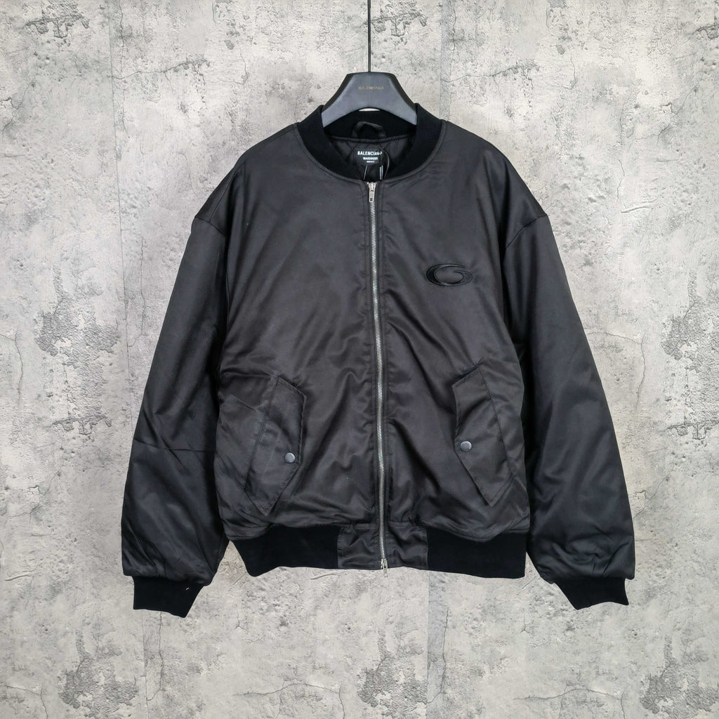 Dark bomber jacket with front zip and ribbed cuffs, oval logo patch at chest