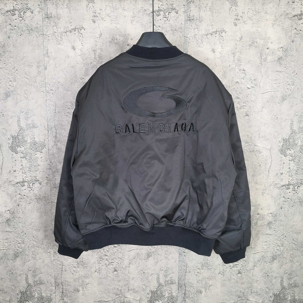 Dark bomber jacket back view with printed BALENCIAGA lettering and oval emblem