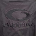 BALENCIAGA lettering and oval logo detail on dark bomber jacket back