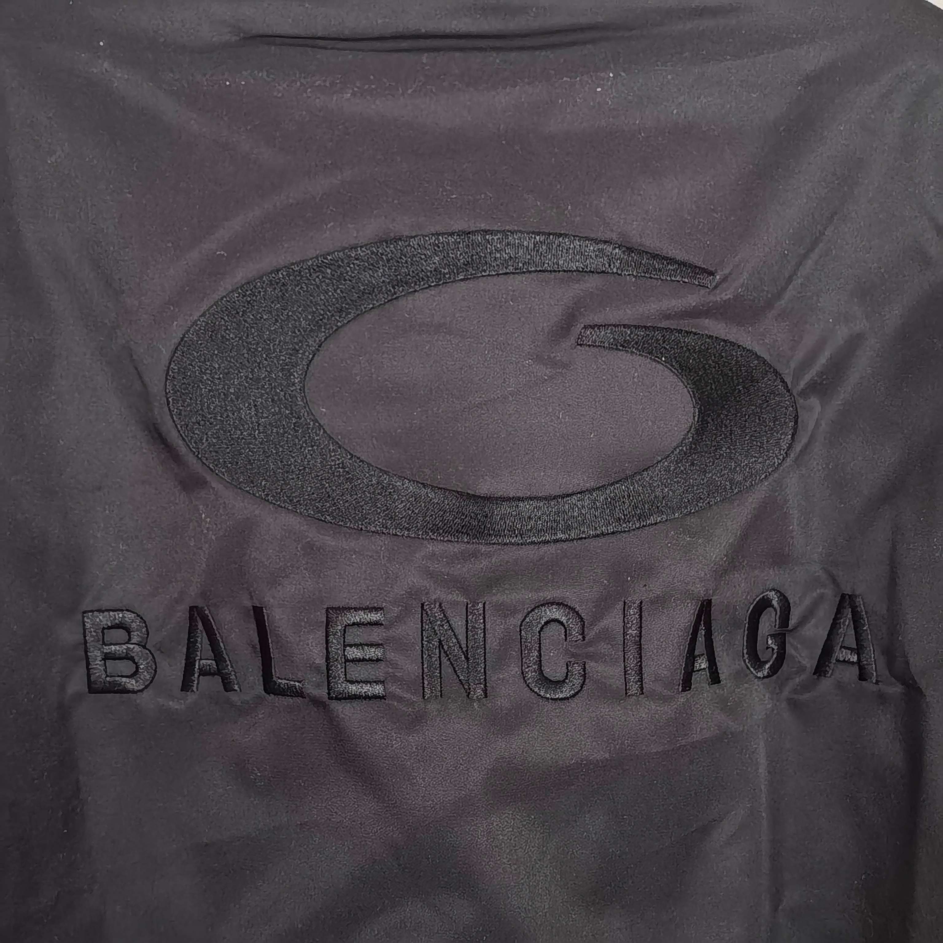 BALENCIAGA lettering and oval logo detail on dark bomber jacket back