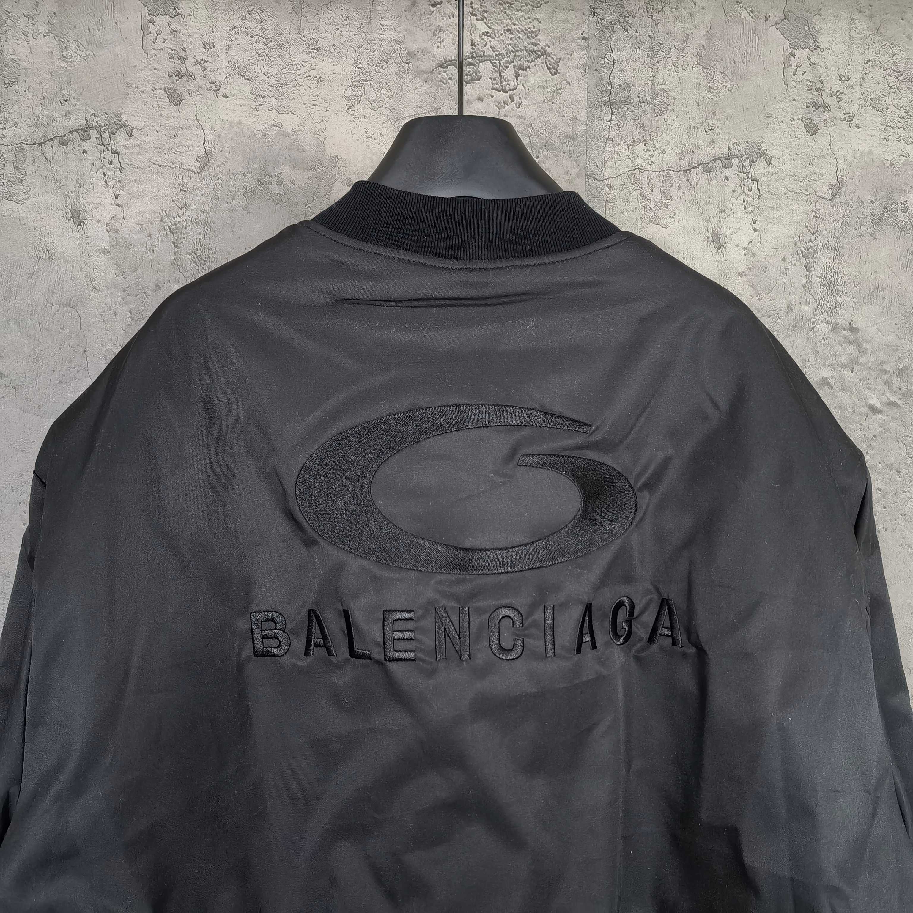 Dark Balenciaga jacket with oval logo and BALENCIAGA text on the back