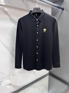 Navy long-sleeve button-up shirt with gold buttons and small chest logo crest