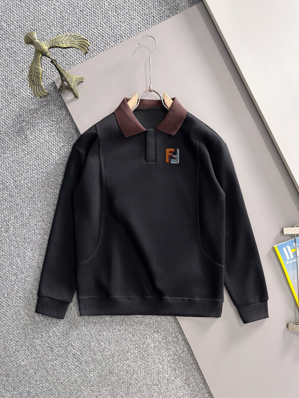 Black long-sleeve sweatshirt with burgundy collar and F logo front
