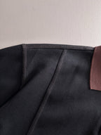 Black sweatshirt collar seam with burgundy trim panel