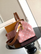 Louis Vuitton handbag with pink monogram print, tan leather trim, and top handle detail