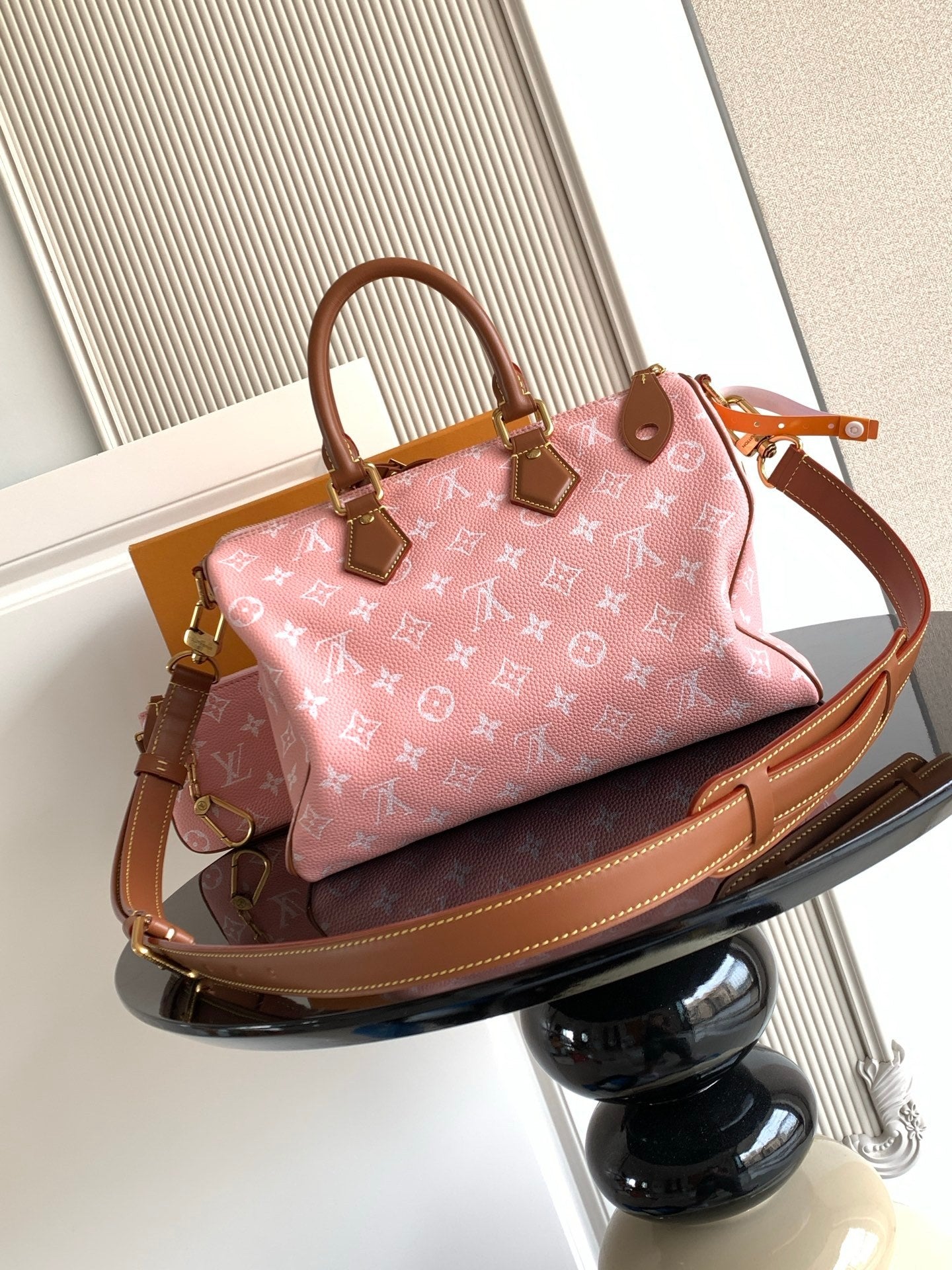 Louis Vuitton pink monogram handbag with tan leather handles and crossbody strap