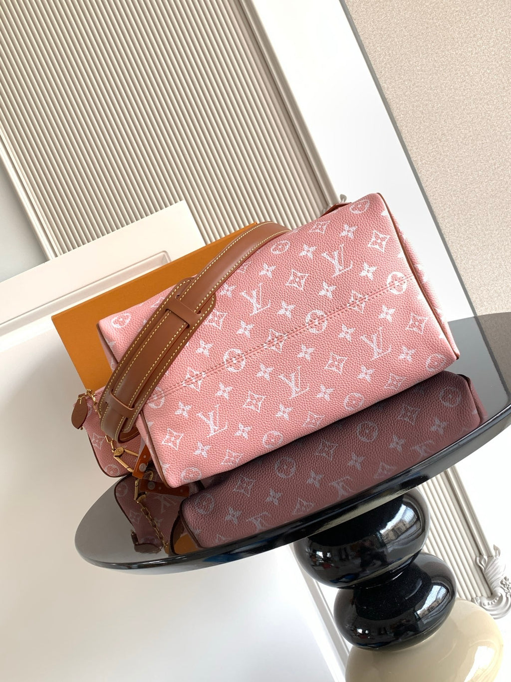 Louis Vuitton pink monogram handbag with tan leather straps and front pocket tab