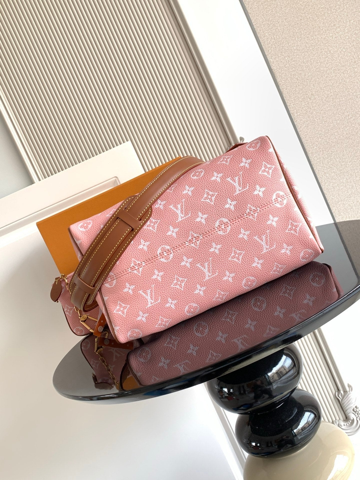 Louis Vuitton pink monogram handbag with tan leather straps and front pocket tab