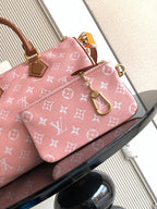Louis Vuitton pink monogram handbag front view with tan leather handles and strap