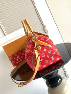 Louis Vuitton handbag in red monogram print with tan shoulder strap and gold hardware