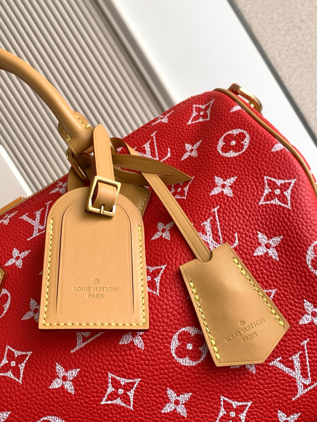 Louis Vuitton handbag red monogram with tan leather luggage tags and gold hardware