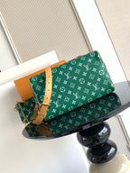 Louis Vuitton green monogram handbag with tan shoulder strap and hanging key pouch