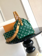Louis Vuitton green monogram handbag with tan handles and detachable shoulder strap