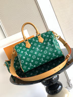 Louis Vuitton green monogram satchel with tan trim and structured top handles