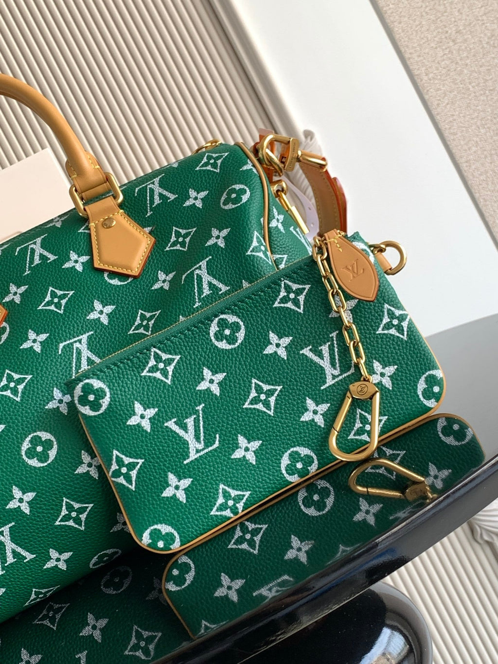 Louis Vuitton green monogram handbag with tan chain strap and small hanging accessories