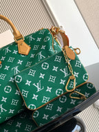 Louis Vuitton green monogram handbag with tan chain strap and small hanging accessories