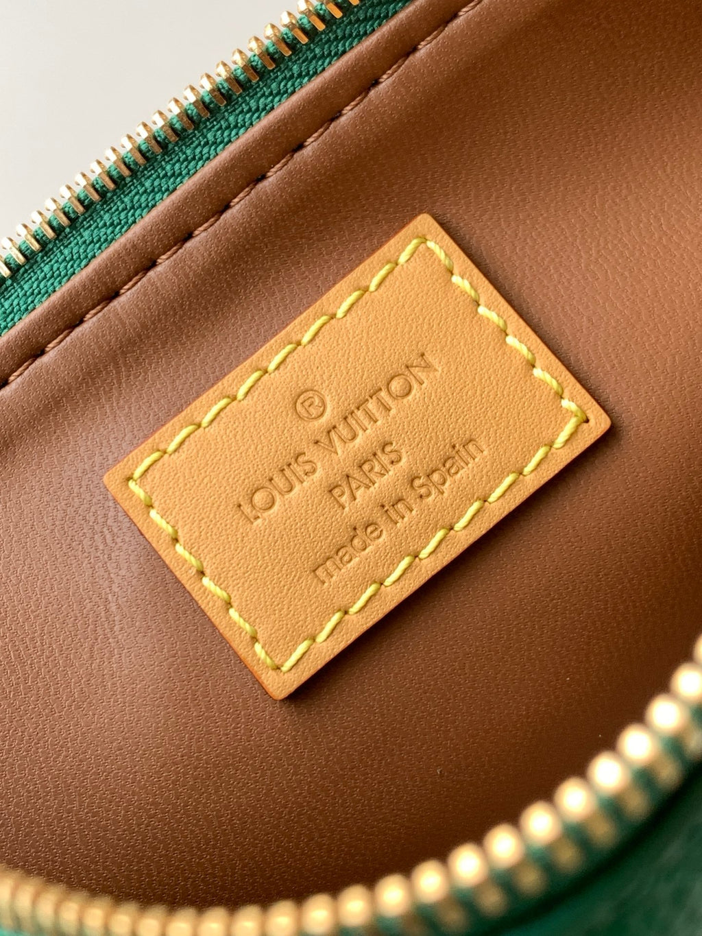 Louis Vuitton bag interior leather label reading Louis Vuitton Paris made in Spain