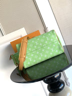 Louis Vuitton mini handbag, green monogram print with tan zipper trim and handle