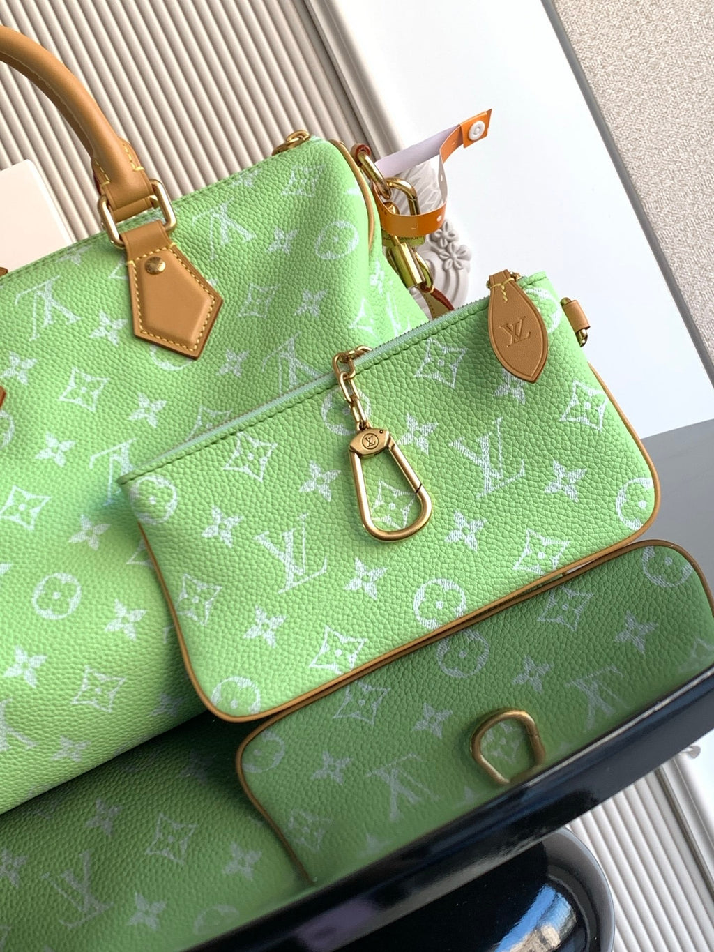Louis Vuitton mini handbag, green monogram print with tan hardware and strap details