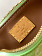 Louis Vuitton mini handbag interior tag detail with leather patch and gold stitching