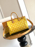 Louis Vuitton yellow monogram handbag with long shoulder strap and rectangular base