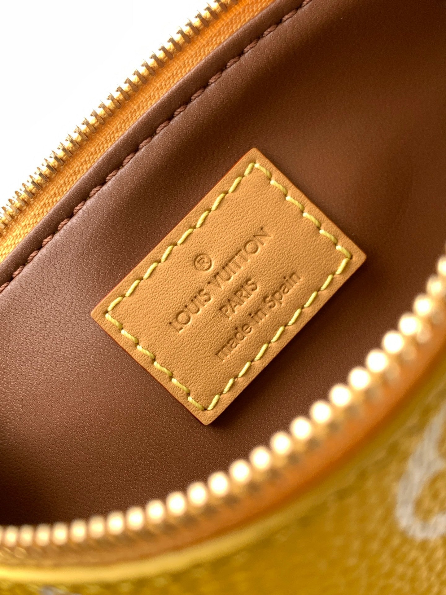 Louis Vuitton handbag tan leather label with stitched edge on gold zipper trim