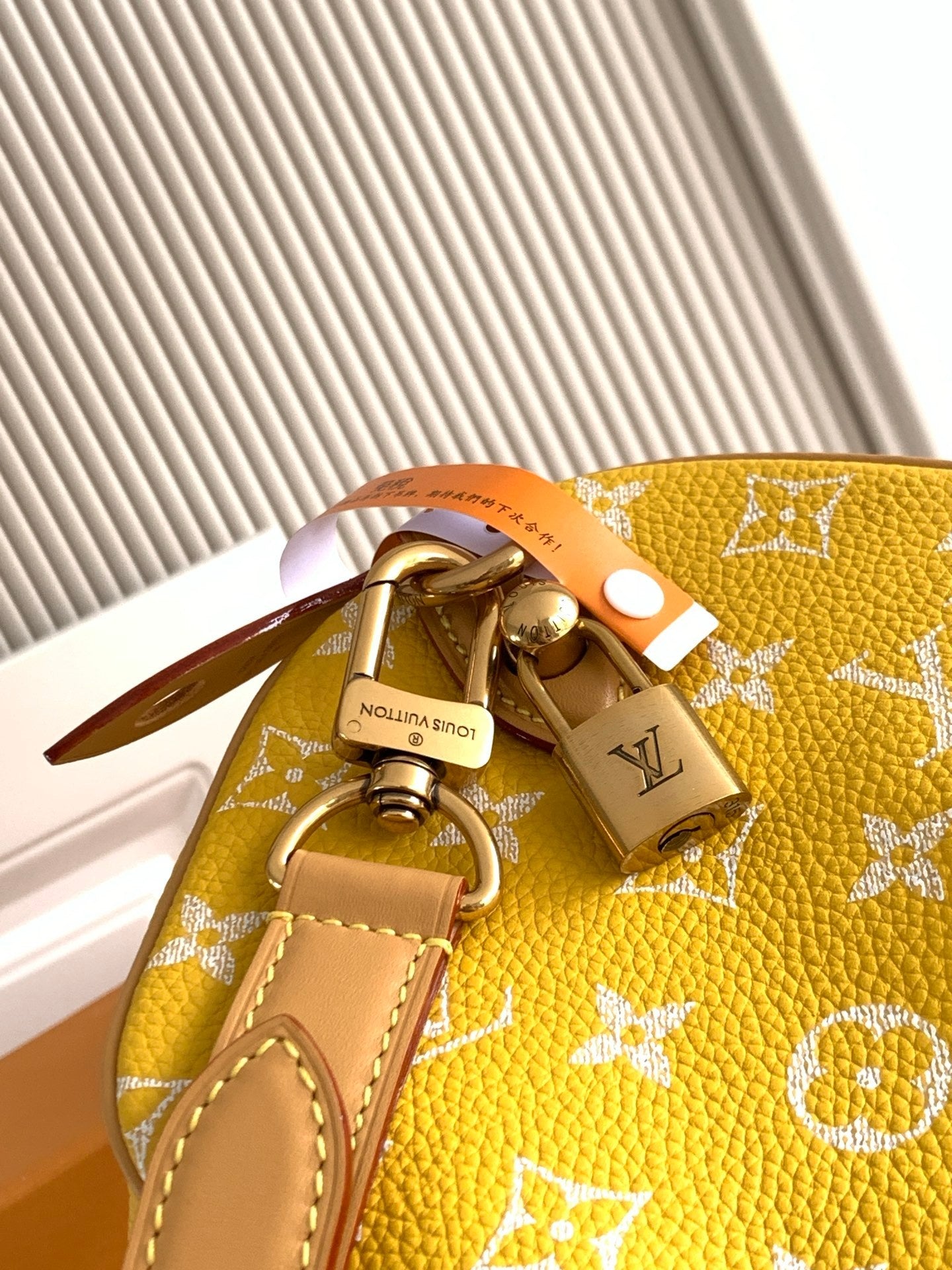 Louis Vuitton yellow monogram handbag with gold chain and logo plate detail