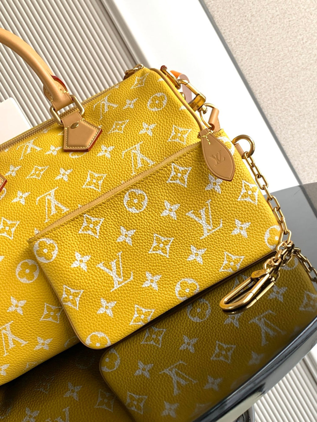 Louis Vuitton yellow monogram handbag with zipper front pocket and key charm