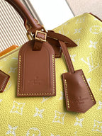 Louis Vuitton bag closeup: yellow monogram with brown leather luggage tags